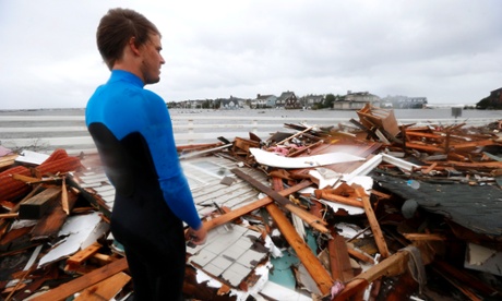 Currie Wagner looks over the debris from his grandmother Betty Wagner's house, destroyed by Sandy, in New Jersey. Photograph: Julio Cortez/AP